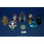 Eight glass paperweights to include four conical shape with pink flowers, etc.