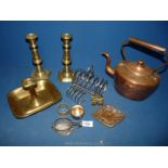 A small copper kettle with lid, a pair of brass candlesticks, brass match holder, etc.