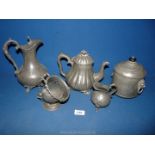 A selection of pewter to include; tea caddy, teapot, decanter, sugar bowl and scuttle scoop.