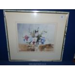 A framed and mounted Watercolour depicting a vase of flowers, indistinctly signed lower right,