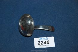 A Silver caddy Spoon having an oval bowl and flattened handle, engraved with entwined initials T.B.
