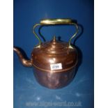 A large copper kettle with brass handle ( some dents).