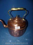 A large copper kettle with brass handle ( some dents).
