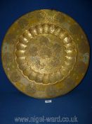 A large brass charger with peacock decoration, 59 cm diameter.