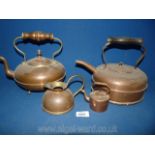 Two copper kettles one with acorn finial, miniature kettle and small jug.