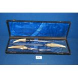 A cased three piece carving set including horn handled carving knife (8") and fork,