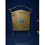 An Art Deco metal/brass firescreen having blue circles.