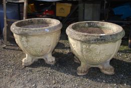 A large pair of concrete Planters having grape design and standing on four splayed feet,