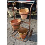 A metal sack truck converted to a flower stand.