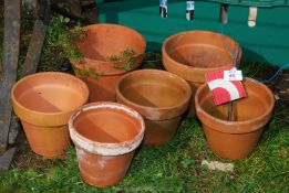 Six various sized terracotta pots.