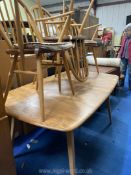 An Ercol Golden Dawn dining table, 58 1/2'' extending to 98'' approx.