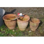 Three graduated terracotta garden planters - approx. 9" diameter x 7 1/2"-10" tall.