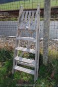 A four rung wooden step ladder.
