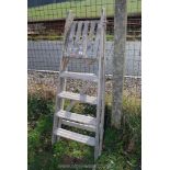 A four rung wooden step ladder.