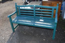 A heavy possibly teak-wood green painted garden Bench, 59" wide x 39" high x 21 1/2" deep.