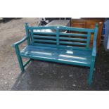 A heavy possibly teak-wood green painted garden Bench, 59" wide x 39" high x 21 1/2" deep.