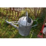 A galvanised watering can.