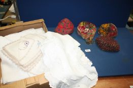 A box of linen included damask, colourful skull caps, etc.