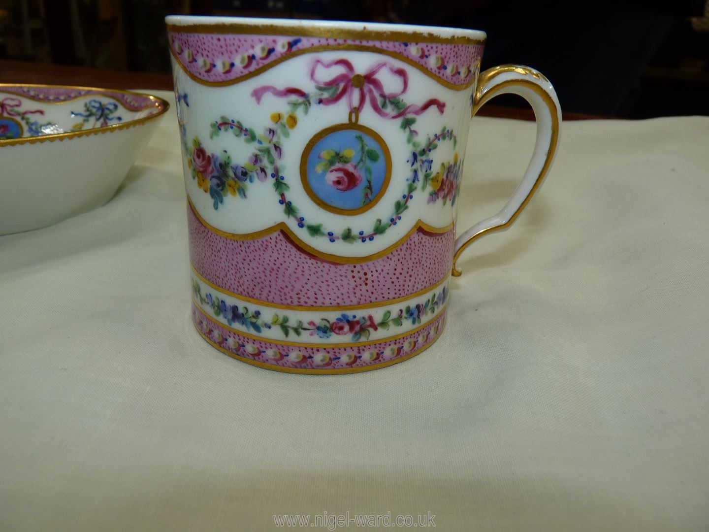 A Sevres coffee can and saucer, painted with floral garlands against a mottled salmon pink ground, - Image 10 of 13