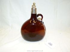 A brown glass Flask with silver plated collar and stopper, damaged handle, cork stopper a/f.