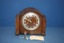 An Enfield mantle clock with Arabic numerals, with key and pendulum,