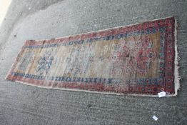A well worn patterned runner in red, pink and brown shades, 101 1/2'' x 30''.