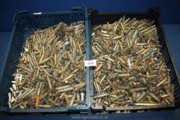 Two trays of empty brass shell cases.