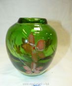 A heavy green art glass Graal vase, having inset floral design and cased in clear glass,