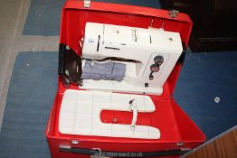 A Bernina electric sewing machine in red hard case, with foot control pedal.