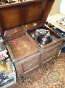 A ''Gilbert - The World's Best Music'' Oak finished Cabinet Gramophone having a record storage