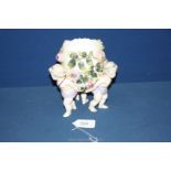 A Sitzendorf porcelain table centrepiece of an egg shaped vessel encrusted with roses and foliage