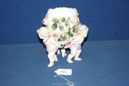 A Sitzendorf porcelain table centrepiece of an egg shaped vessel encrusted with roses and foliage