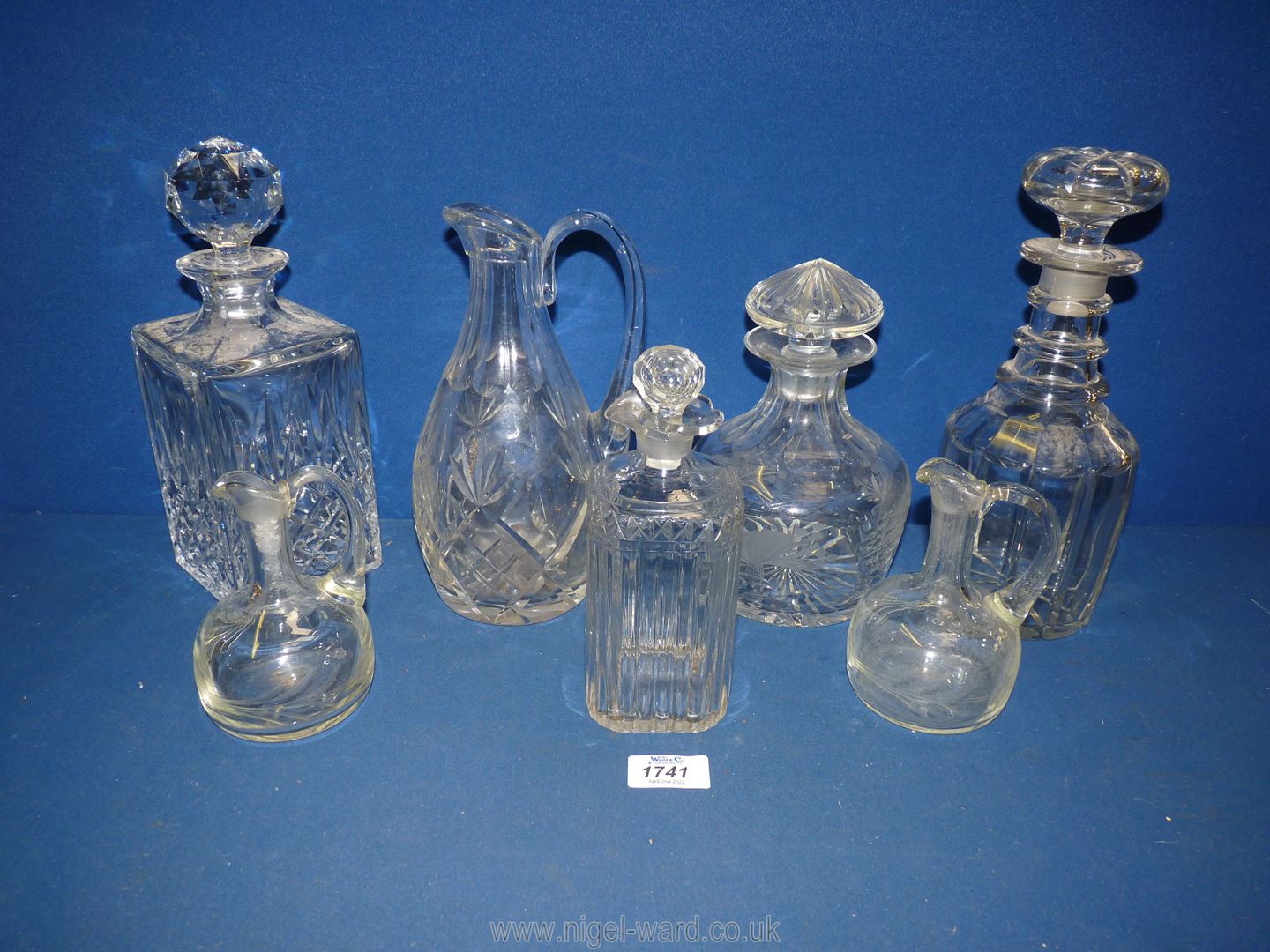 Four glass decanters and stoppers, a water jug and two small vinaigrette/ oil bottles.