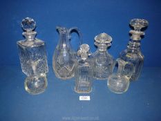 Four glass decanters and stoppers, a water jug and two small vinaigrette/ oil bottles.