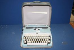 A Brother Deluxe Typewriter in carrying case, 12'' x 12''.