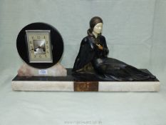 An Art Deco metal and marble Clock with figure of seated lady,