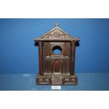 A Folk art carved sandstone watch stand, possibly Welsh, in the shape of a pillared chapel facade,