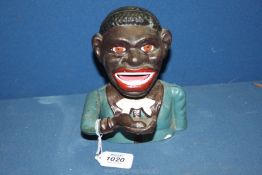 A cast iron hand operating money box of an African gent, 6 1/2" tall.