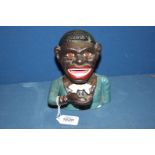 A cast iron hand operating money box of an African gent, 6 1/2" tall.