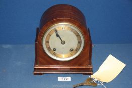 A Dent mantle clock with Roman numerals, with key, 7 1/2'' wide x 4 3/4'' deep x 7 1/2'' tall.