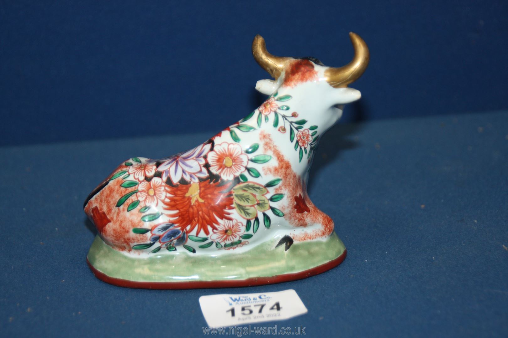 An antique Delft pottery figurine of a seated cow decorated in polychrome; (damage to one horn), - Image 4 of 4