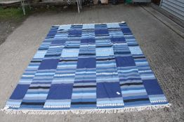 A bordered, patterned and fringed blue ground Rug, 68'' x 97'' .