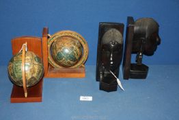 A pair of wood Bookends in the form of a pair of world globes,