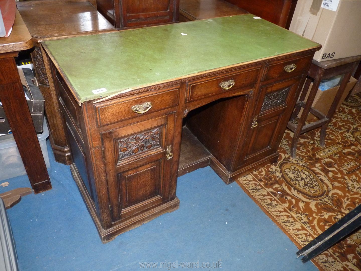 A diminutive circa 1900 Oak Kneehole Desk having three frieze drawers,