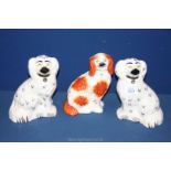 A pair of white Beswick Spaniels, plus one other, a/f, 8'' tall.