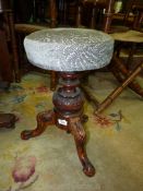 An elegant Walnut three legged based Piano Stool,