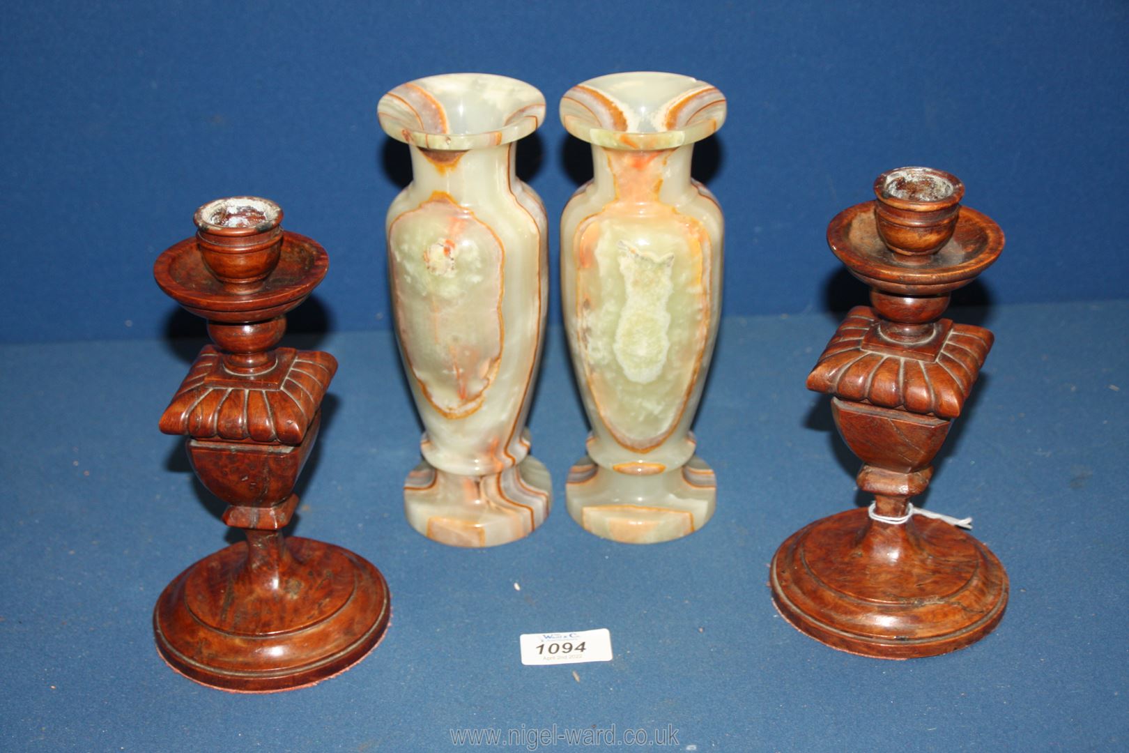 A pair of quality Georgian heavy treen candlesticks having square vase carved on round bases,