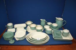 A quantity of Denby Pottery to include casserole dish, various serving dishes, jugs and cups, etc.