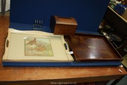 A wooden tray with brass handles and corners,