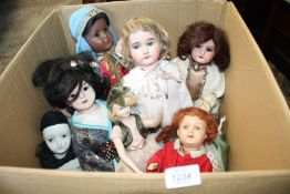 A good quantity of porcelain headed dolls, some on stands including oriental girl, Pierrot clown,